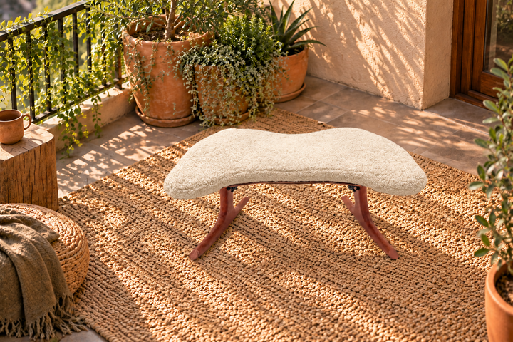 HoM Self Shelf meditation chair with a Glacier white cushion on a woven rug in a sunlit balcony garden
